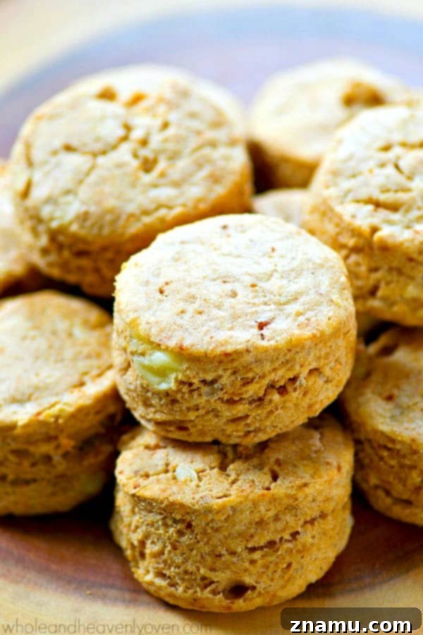 Fluffy Cheesy Potato Coconut Oil Biscuits 3 Close-up of golden-brown cheesy coconut oil biscuits on a baking sheet.