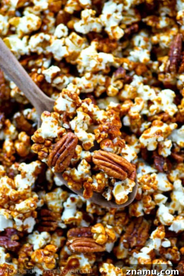 Pecan Praline Cinnamon Popcorn 7 A large tray filled with freshly baked Cinnamon Roll Pecan Caramel Popcorn, ready to be broken into pieces