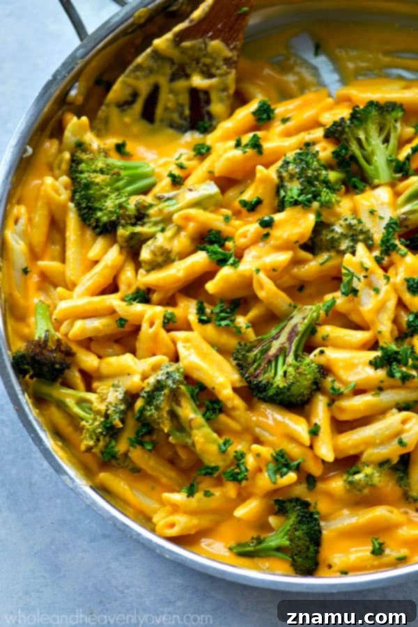 Creamy Butternut Squash and Roasted Broccoli Penne Skillet 6 A close-up of creamy alfredo sauce being blended with roasted butternut squash for an extra smooth consistency and vibrant color.
