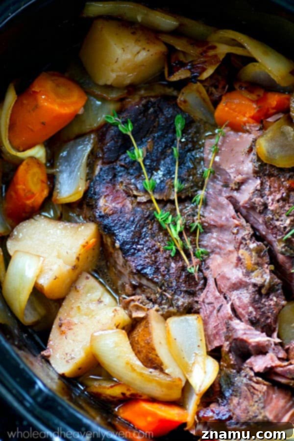 Slow-Cooked Balsamic Pot Roast with Sweet Caramelized Onions and Roasted Potatoes 4 Slow cooker filled with beef chuck roast, potatoes, carrots, and herbs before cooking