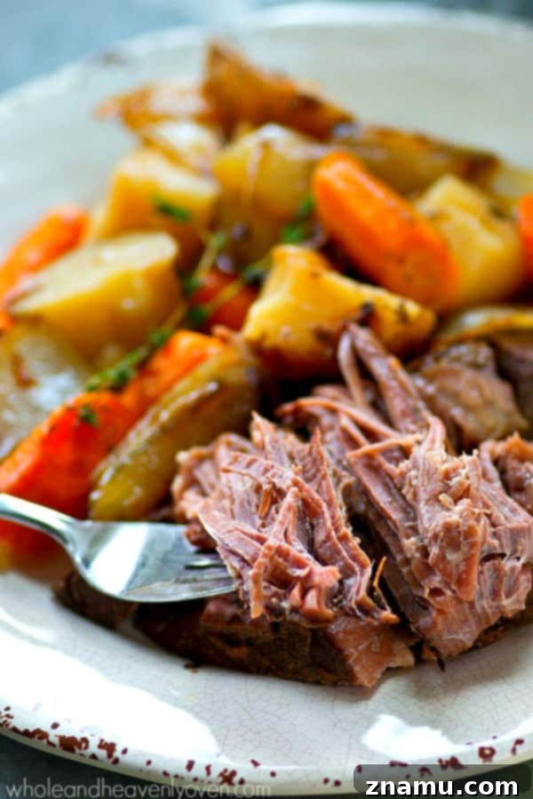 Slow-Cooked Balsamic Pot Roast with Sweet Caramelized Onions and Roasted Potatoes 6 Close-up of a serving of Balsamic Pot Roast topped with golden caramelized onions