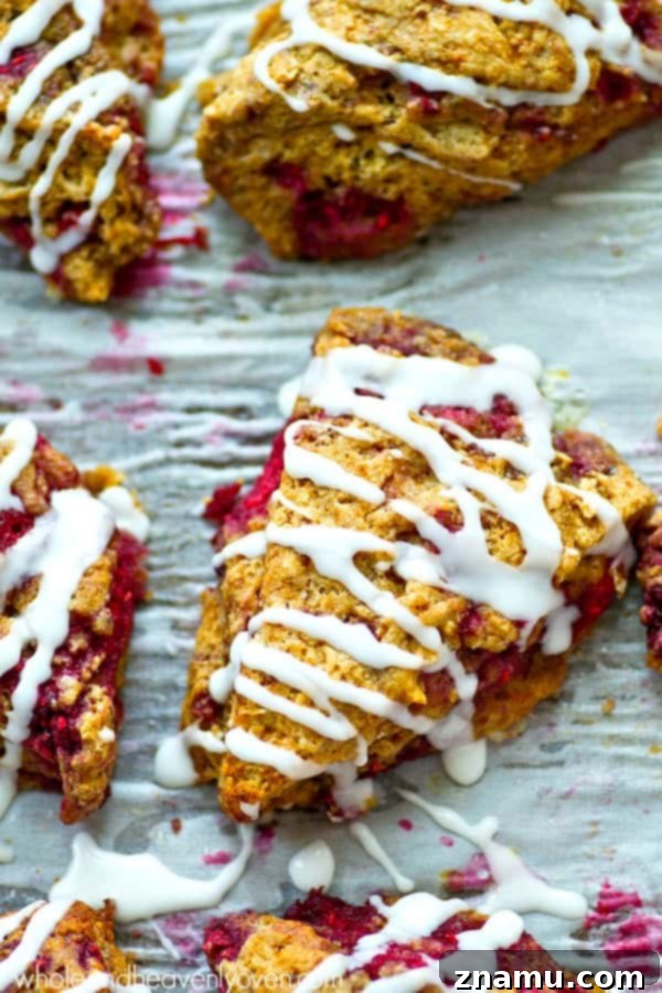 Sweet Glazed Raspberry Eggnog Scone Bites 3 A platter of golden-brown mini eggnog scones, artfully arranged and ready for a festive gathering, highlighting their small, inviting size.