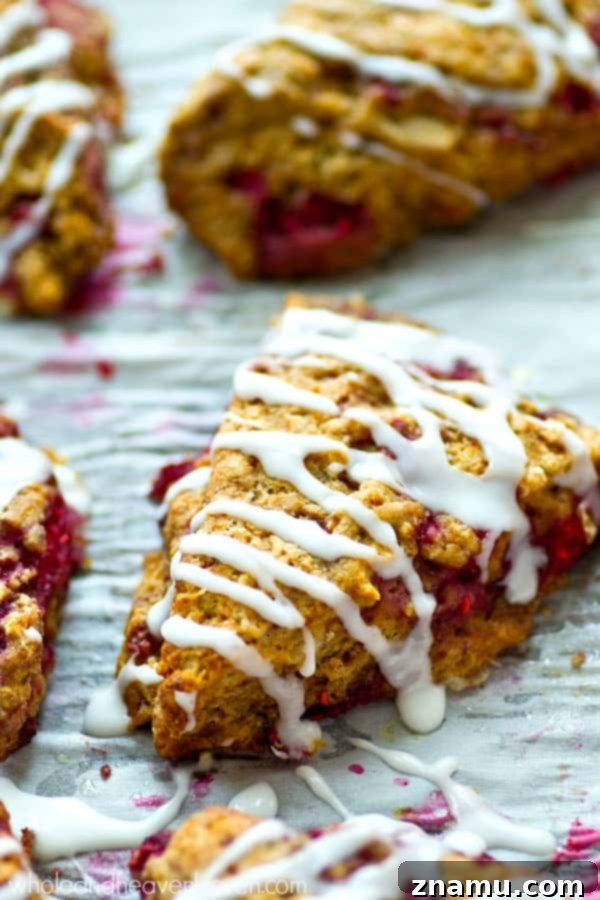 Sweet Glazed Raspberry Eggnog Scone Bites 5 A vibrant overhead shot of the raw scone dough studded with fresh raspberries, before baking, highlighting the beautiful contrast of colors.