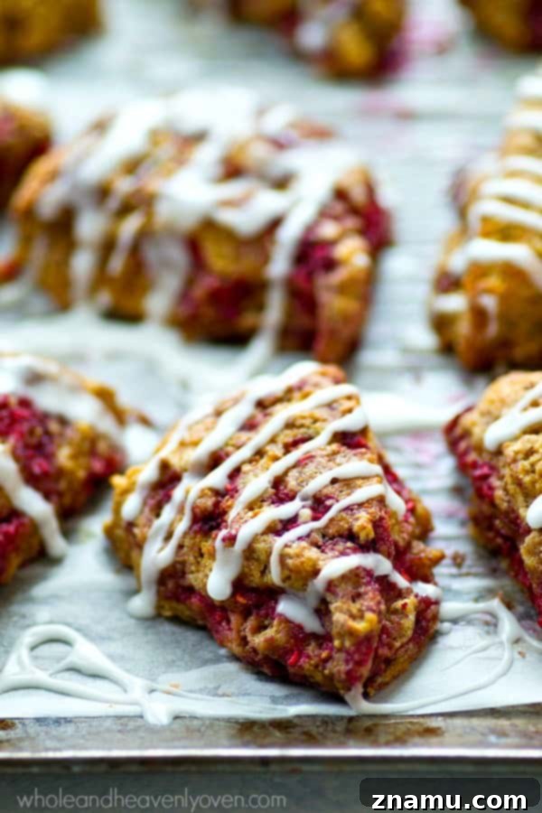 Sweet Glazed Raspberry Eggnog Scone Bites 6 Freshly baked mini eggnog scones cooling on a wire rack, still warm and waiting for their generous drizzle of sweet eggnog glaze.