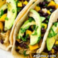 Easy Crockpot Green Chile Chicken Tacos with Fresh Mango Black Bean Salsa 9 Up your taco night game with these INSANELY-easy crockpot green chile chicken tacos! The chicken is unbelievably tender and a mango black bean salsa piled on top brings tons of flavor!