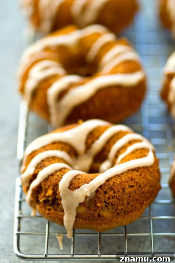 Close-up of a stack of fluffy, baked banana bread donuts.