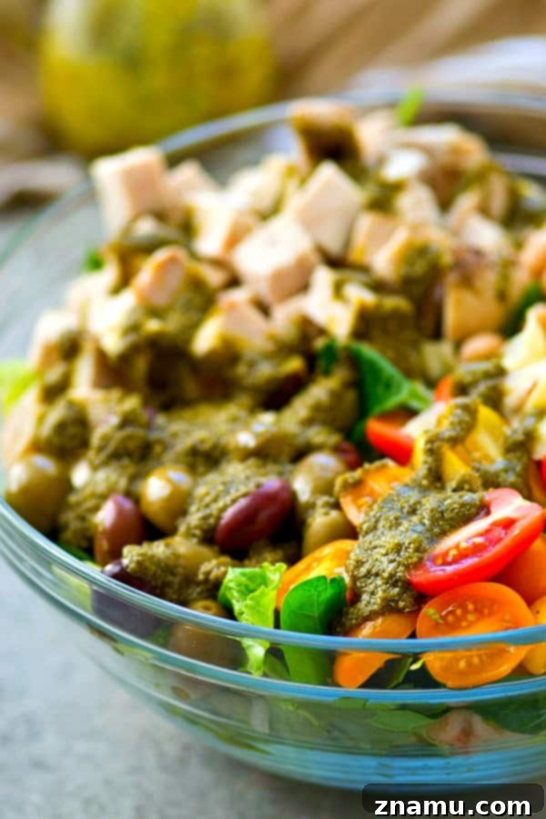 A Taste of Tuscany: Turkey & Pesto Salad 4 A close-up shot revealing the fresh components of the Tuscan turkey salad, including cannellini beans, cherry tomatoes, and sliced olives.