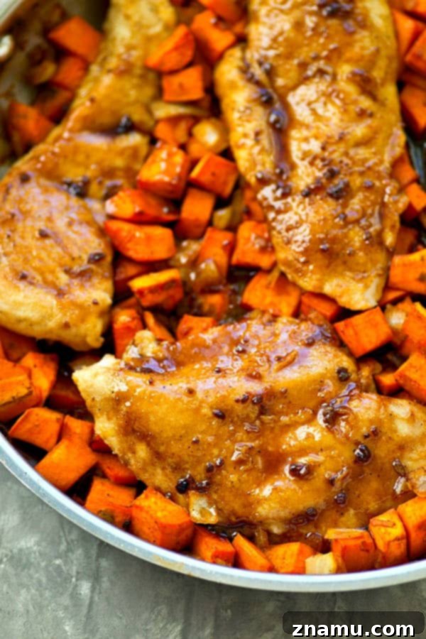 Sticky Maple Chicken & Sweet Potato Hash 4 Maple glazed chicken breasts with sweet potato hash, ready to be served from the skillet.