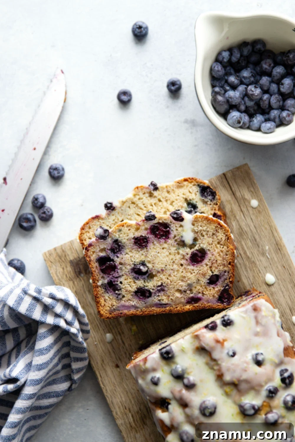 Sunshine Blueberry Banana Bread with Zesty Citrus Glaze 2 Moist blueberry banana bread loaf with a thick citrus glaze drizzle