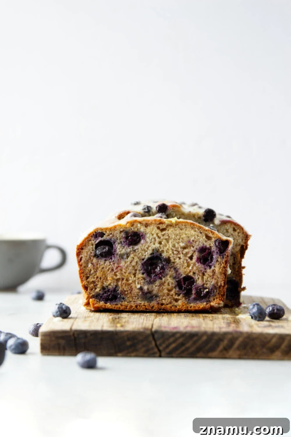 Sunshine Blueberry Banana Bread with Zesty Citrus Glaze 5 Close-up of baked blueberry banana bread loaf with glaze