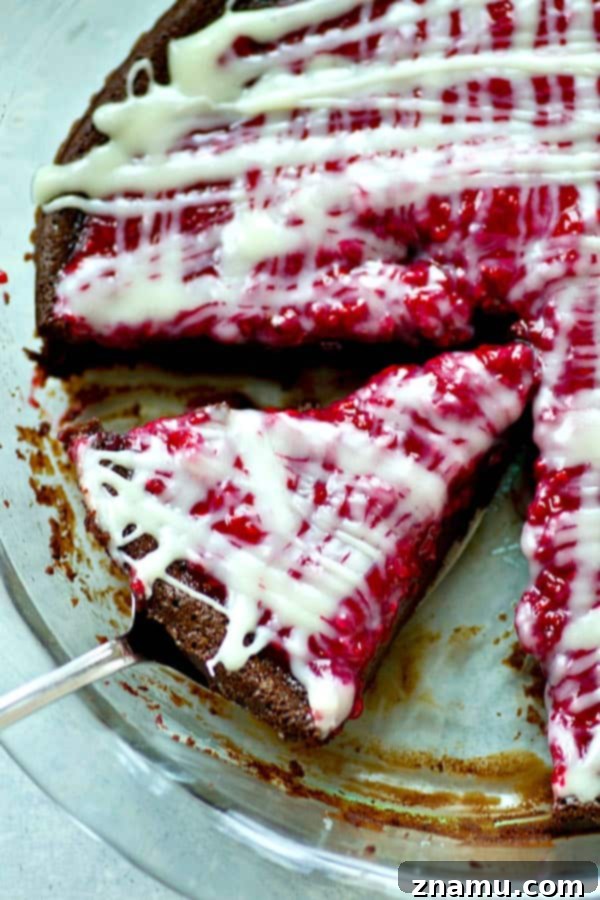 Decadent Flourless Mocha Raspberry White Chocolate Pie 5 A top-down view of the flourless mocha chocolate raspberry pie, showcasing its glossy surface and intricate white chocolate design