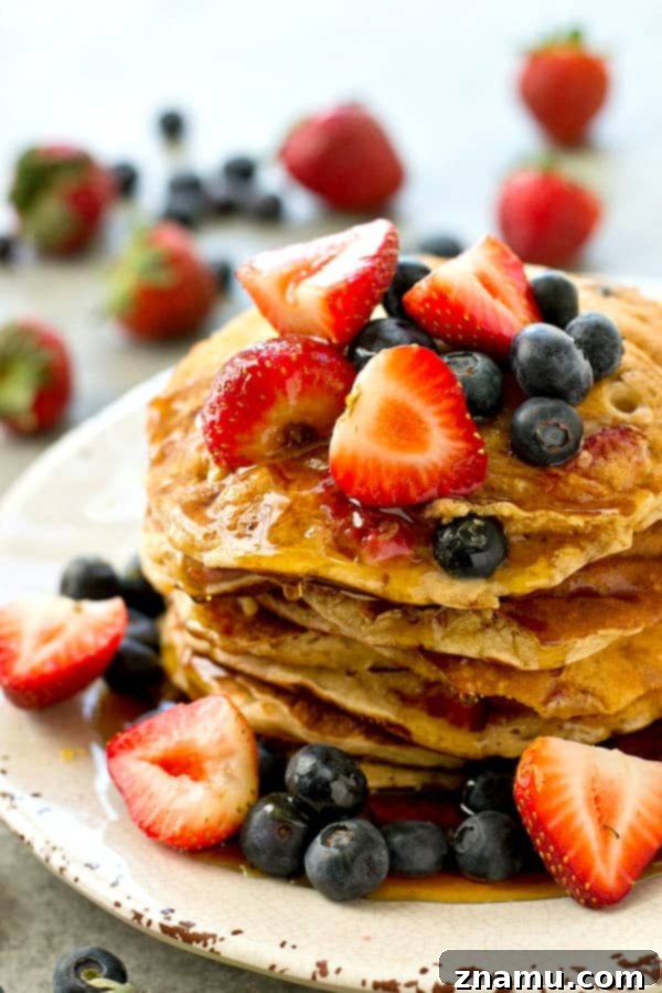 Hearty Berry Multi-Grain Pancakes 5 Multi-grain pancakes loaded with fresh strawberries and blueberries ready to be served