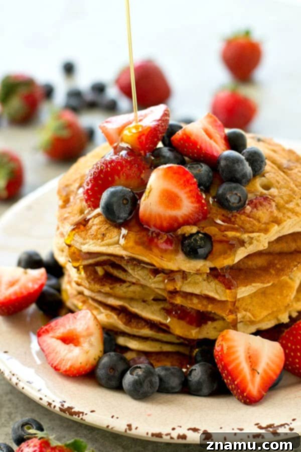 Hearty Berry Multi-Grain Pancakes 6 Serving healthy multi-grain berry pancakes with a generous pour of maple syrup