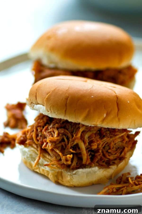 Sweet and Smoky Crockpot Chipotle Maple BBQ Chicken Sandwiches 4 A vibrant bowl of chipotle maple BBQ sauce, highlighting the rich colors and hinting at the sweet and spicy flavors within.