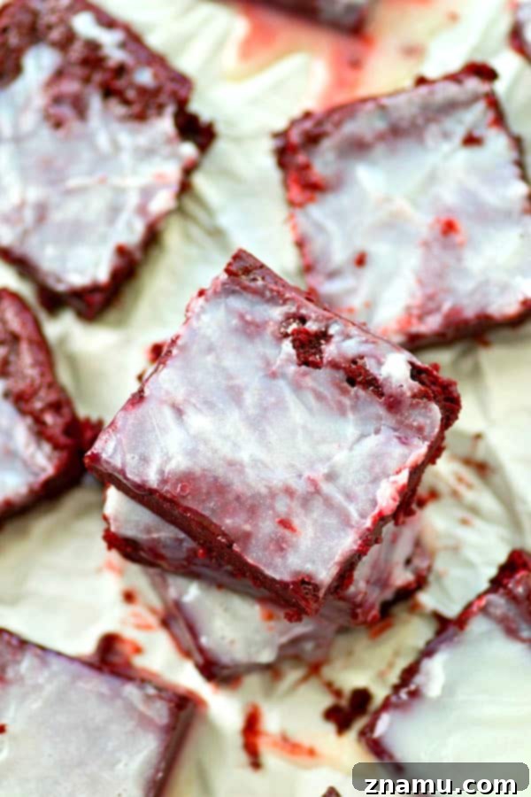 Freshly baked White Chocolate Red Velvet Brownie Bites in a pan before cutting