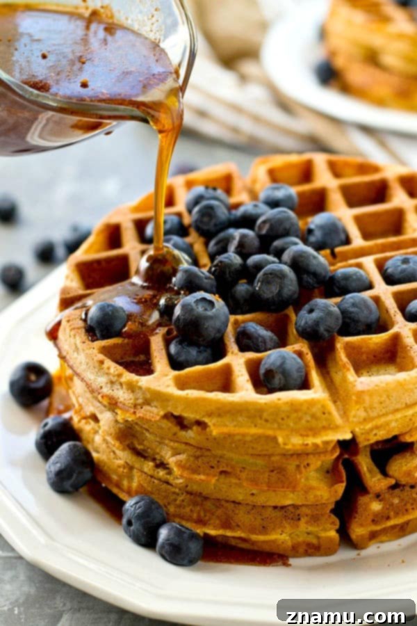 Golden Coconut Waffles with Spiced Maple Chai 4 Golden-brown coconut oil waffles ready for chai maple syrup.