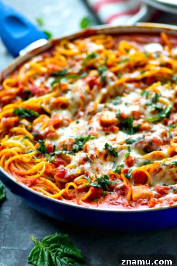One-Pan Creamy Chicken Tomato Basil Spaghetti 3 Close-up of Creamy Chicken Tomato Basil Spaghetti Skillet with noodles visible under Parmesan