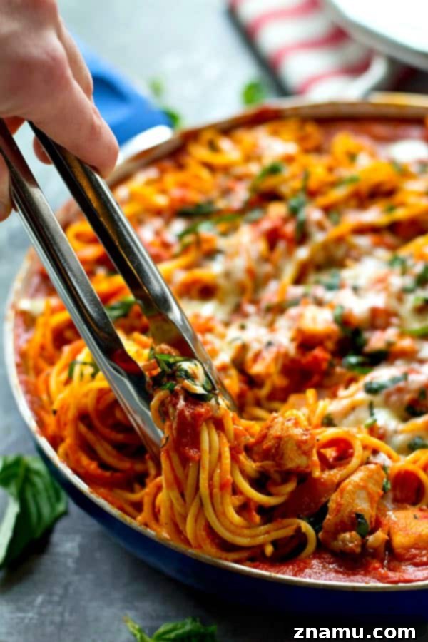 One-Pan Creamy Chicken Tomato Basil Spaghetti 4 Skillet filled with Creamy Chicken Tomato Basil Spaghetti ready to serve
