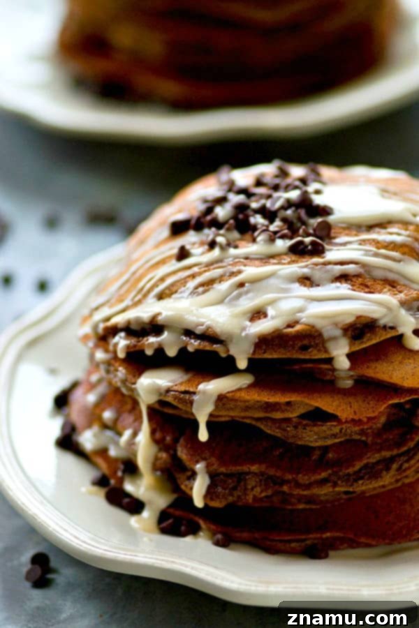 Lighter Double Chocolate Pancakes Espresso Glazed 2 Tall stack of fluffy double chocolate pancakes generously drizzled with espresso glaze.