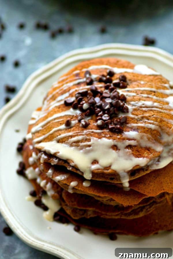 Lighter Double Chocolate Pancakes Espresso Glazed 3 Close-up shot of light and airy double chocolate pancakes on a plate, ready to be served.