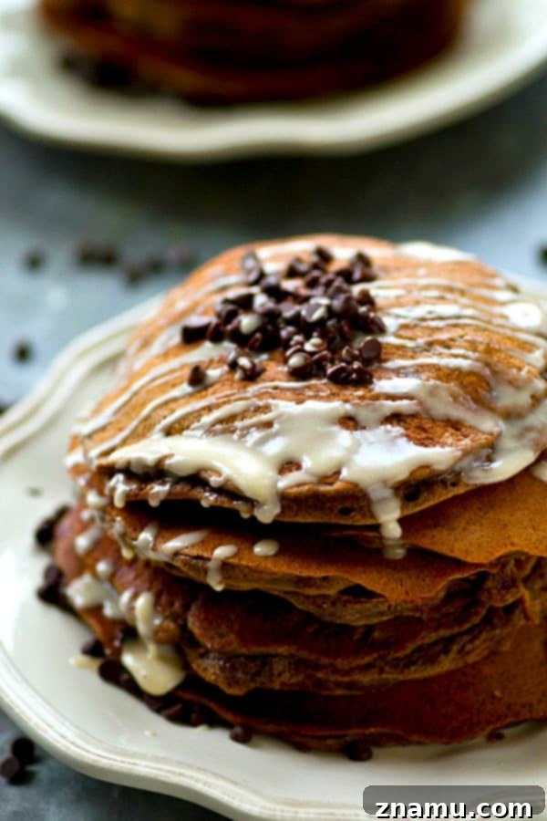 Lighter Double Chocolate Pancakes Espresso Glazed 4 Hand drizzling espresso glaze over a warm stack of double chocolate pancakes.