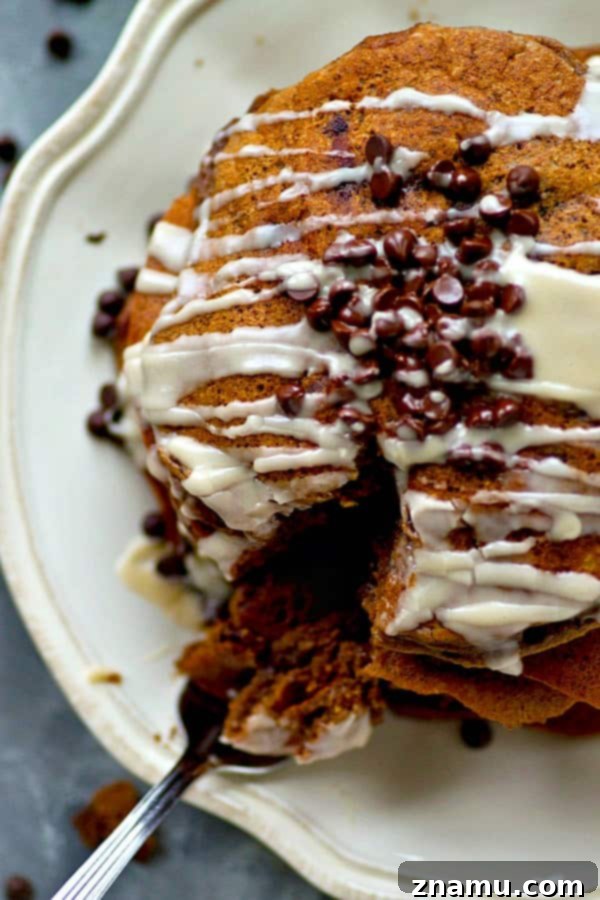 Lighter Double Chocolate Pancakes Espresso Glazed 5 Overhead view of a stack of golden brown, fluffy pancakes studded with chocolate chips.