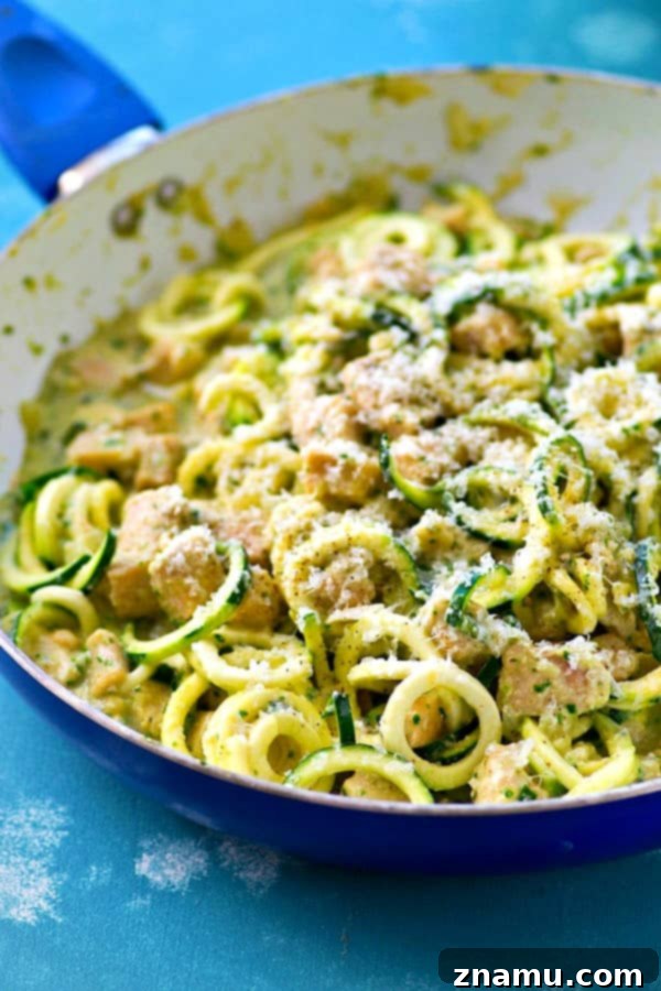 Creamy One-Pot Pesto Chicken Zoodles Alfredo 3 Close-up of creamy pesto alfredo zucchini noodles with chicken and fresh basil