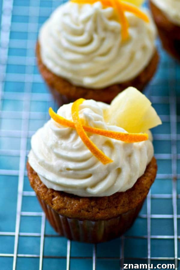 Pineapple Banana Paradise with Zesty Cream Cheese 3 Close-up of a moist Pineapple Banana Cupcake with fluffy cream cheese frosting.