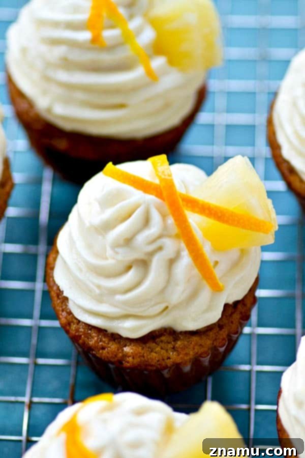 Pineapple Banana Paradise with Zesty Cream Cheese 6 Tall piped Citrus Cream Cheese Frosting on a tropical Banana Pineapple Cupcake.