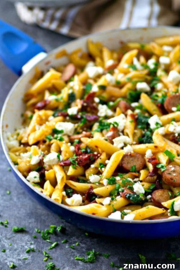 One-Pan Sun-Dried Tomato Sausage & Feta Penne 4 Side view of the savory Sun-Dried Tomato Penne Skillet, garnished with fresh parsley