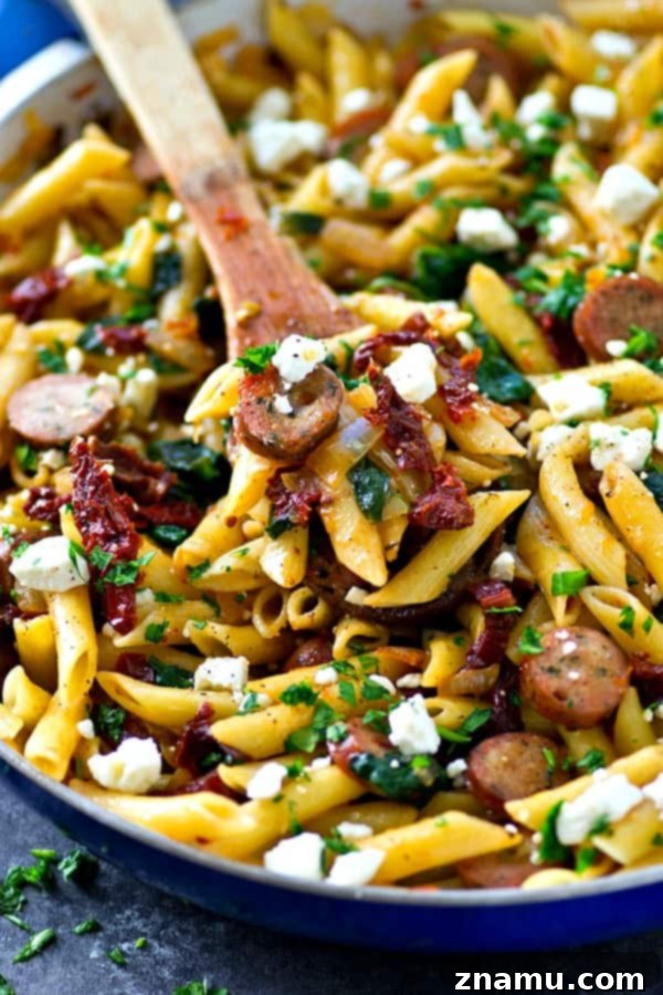 One-Pan Sun-Dried Tomato Sausage & Feta Penne 5 Overhead view of a generous serving of Sun-Dried Tomato Penne Skillet in a bowl, ready to eat