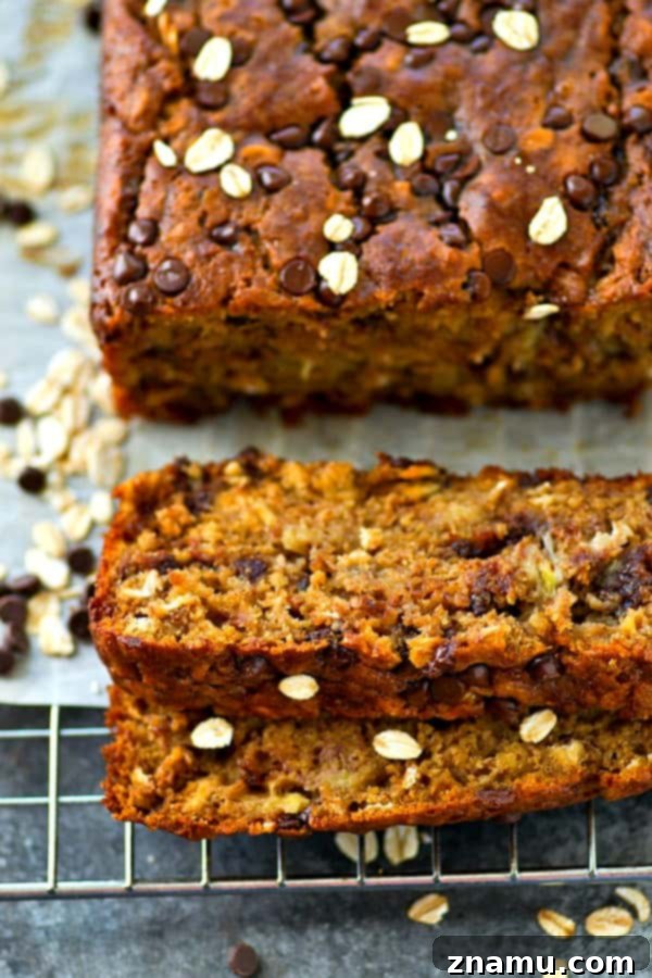 Decadent Oatmeal Chocolate Chip Cookie Banana Bread 3 A generous slice of moist banana bread showcasing the melted chocolate chips and oatmeal texture.