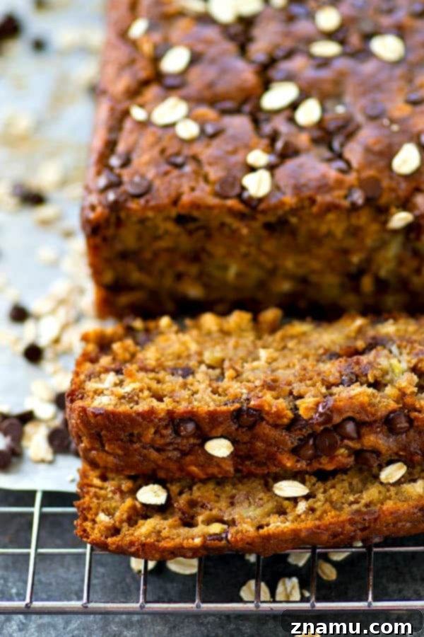 Decadent Oatmeal Chocolate Chip Cookie Banana Bread 4 Overhead shot of a banana bread loaf, revealing its rich, golden-brown crust and generous filling.