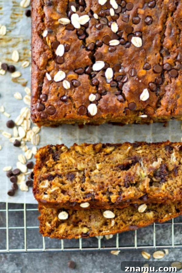 Decadent Oatmeal Chocolate Chip Cookie Banana Bread 5 A slice of the warm, moist banana bread, showing steam rising, ready to be savored.