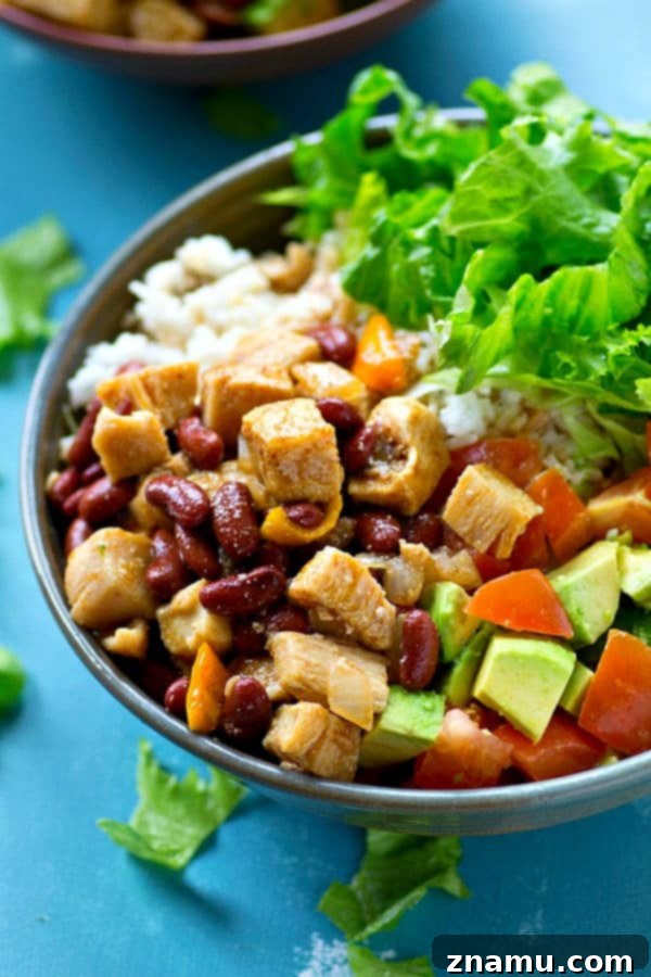 Southwest Chipotle Chicken Bowls 3 Close-up of a colorful Chipotle Chicken & Beans Rice Salad Bowl with avocado and lettuce
