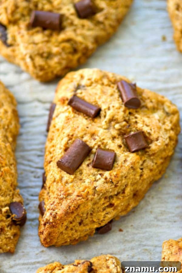 Several banana chocolate chunk scones arranged on a plate, ready to be enjoyed with coffee.