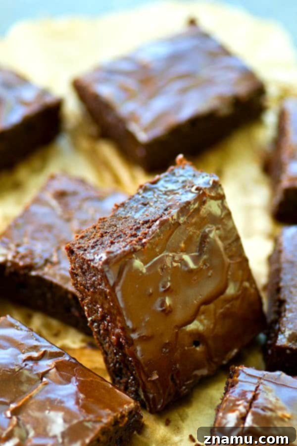 Close-up of a single mocha-glazed brownie, showing its dense, fudgy interior and shiny topping.
