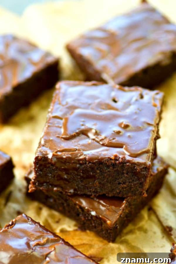 A delicious mocha-glazed brownie ready to be sliced, emphasizing the rich texture.