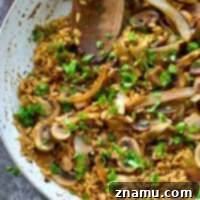 Flavorful caramelized onions, mushrooms, and balsamic are the star flavors in this SUPER-creamy risotto that comes together easily in one pan in less than 30 minutes!