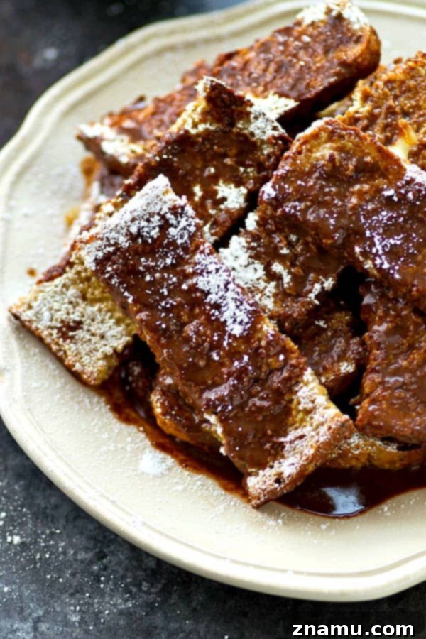 Decadent Espresso French Toast Sticks with Mocha Glaze 4 Pile of espresso french toast sticks with a spoon, showing their inviting texture