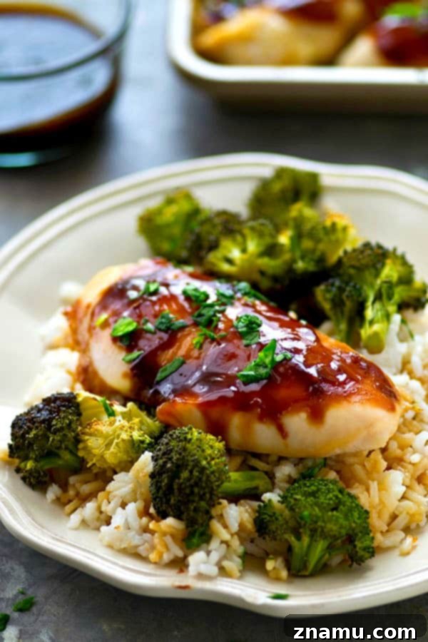 One-Pan Teriyaki Chicken and Roasted Broccoli 6 Close-up of baked teriyaki chicken and roasted broccoli, garnished with fresh parsley.