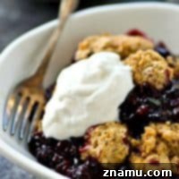 Golden Oat Berry Cobbler 8 The BEST mixed berry cobbler you'll ever have! Fluffy oat biscuits paired with a double-whammy of juicy berries make for one killer cobbler. Eat it warm with lots of whipped cream!