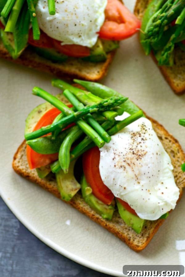 Spring Avocado Toast Delights 4 Overhead view of a prepared Spring Farmer's Market Avocado Toast with a golden poached egg