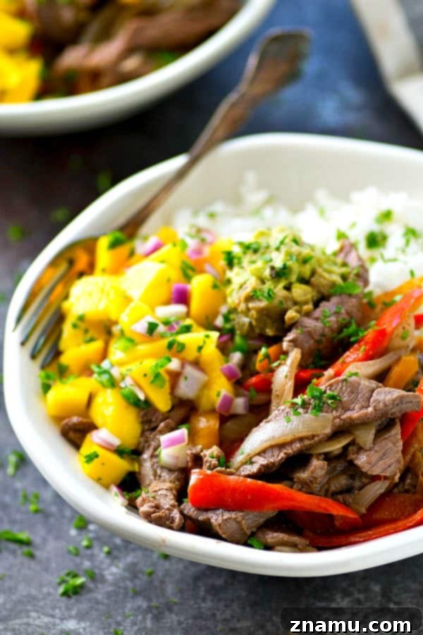 Steak and Peppers Rice Bowls with Mango Pico de Gallo 3 Overhead shot of a colorful Steak and Peppers Rice Bowl, showcasing the fresh ingredients.