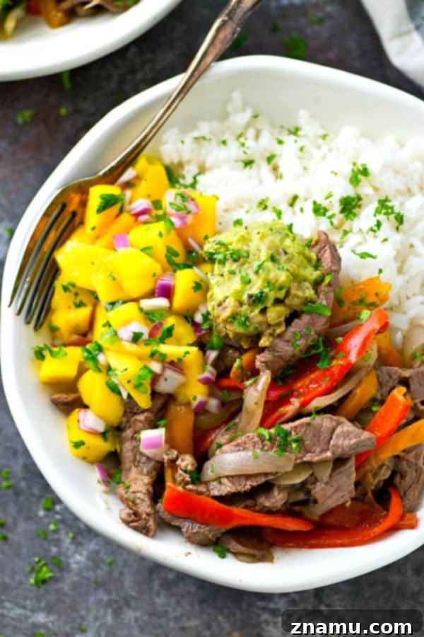Steak and Peppers Rice Bowls with Mango Pico de Gallo 4 Close-up of steak strips, sweet peppers, onion, and garlic sautéing in a skillet, ready for the rice bowls.