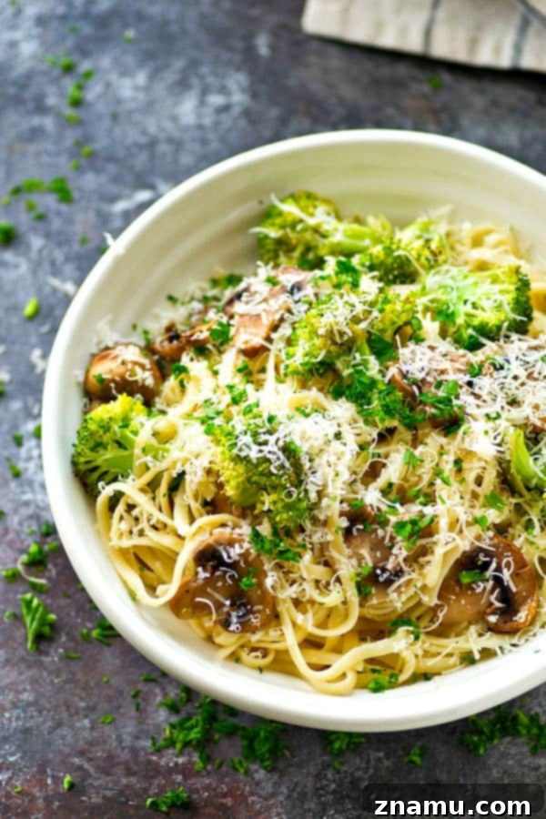 Browned Butter Parmesan Fettuccine with Umami-Rich Mushrooms and Vibrant Broccoli 6 Freshly grated Parmesan cheese over pasta