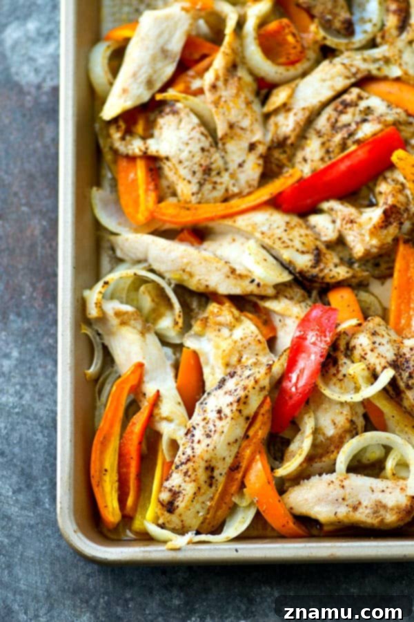 Sheet Pan Spicy-Sweet Chicken Tacos 3 Sheet pan chile-rubbed chicken and sweet peppers ready to be loaded into tortillas for easy and flavorful tacos.