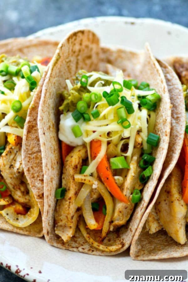 Sheet Pan Spicy-Sweet Chicken Tacos 4 Close-up of loaded sheet pan chicken and sweet pepper tacos with fresh toppings.