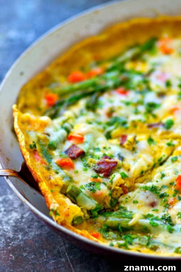 Swiss Cheese, Asparagus, and Bacon Frittata 2 A vibrant Swiss Cheese Asparagus Bacon Frittata, fresh from the skillet, showcasing its rich golden color and generous toppings.