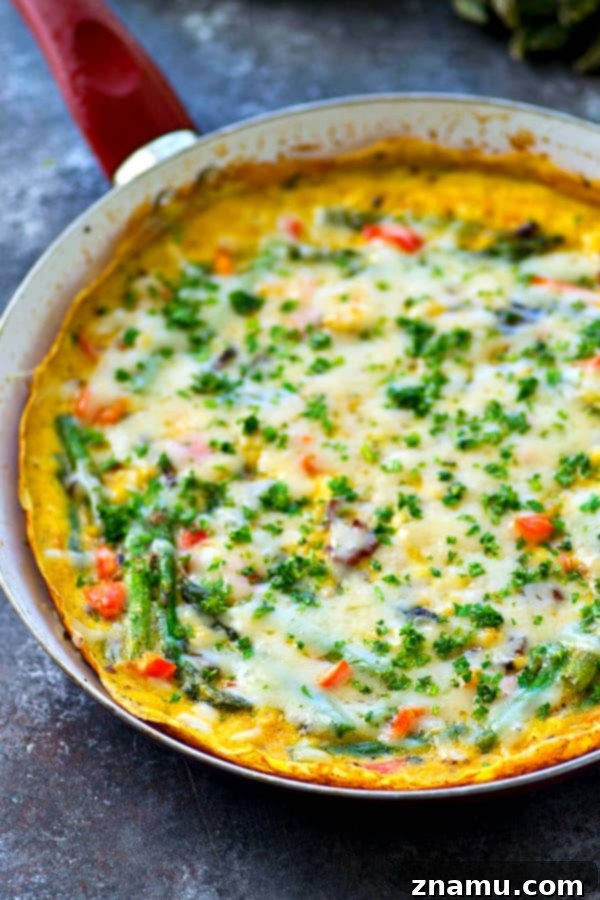 Swiss Cheese, Asparagus, and Bacon Frittata 3 Close-up shot of the Swiss Cheese Asparagus Bacon Frittata, highlighting the tender asparagus pieces and crispy bacon embedded within the fluffy eggs.